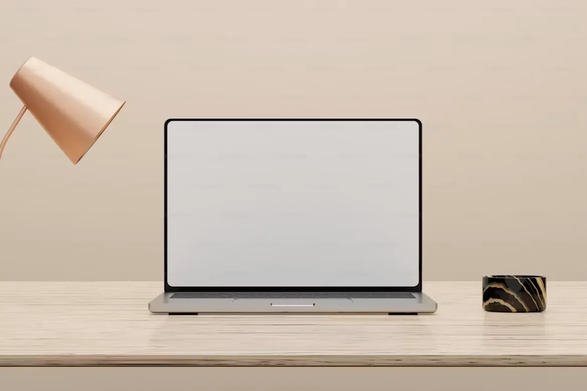 A minimal workspace with a laptop and desk lamp